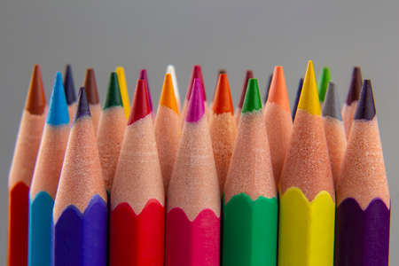 set of color pencils on a gray background. drawing tools. palette in creativity