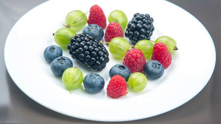 Assorted fresh different berries on a white plate. useful vitamin healthy food fruit. healthy...