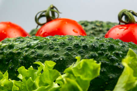 Fresh cucumbers and tomatoes and lettuce. vitamins and light breakfast