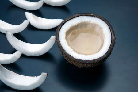 pieces of chopped coconut on a dark background. vitamin fruits. healthy foodの写真素材