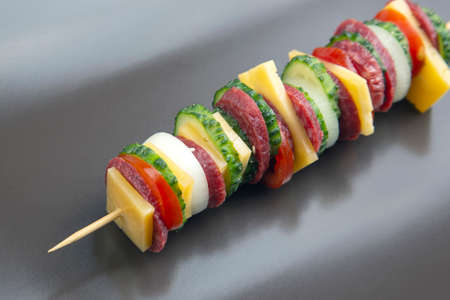 sliced ââpieces of sausage, salami, cheese, cucumber and tomato. fast food. ingredients for pizza. calories and dietの写真素材