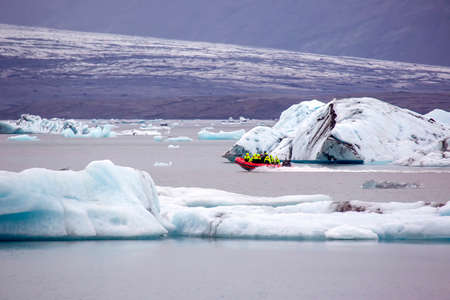 People travel on a special amphibian boat on the ice lagoon in Iceland
