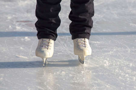 legs of a skating man on an ice rink. hobbies and leisure. winter sports