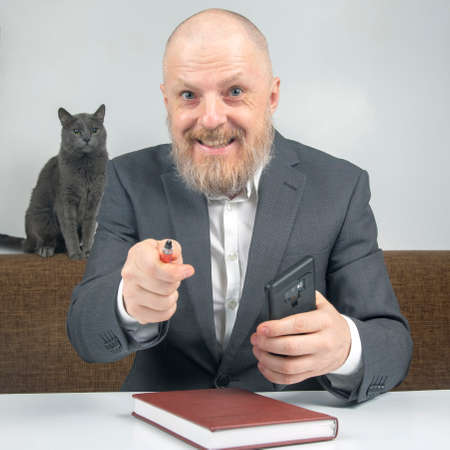 businessman and gray cat at home office working with documents.