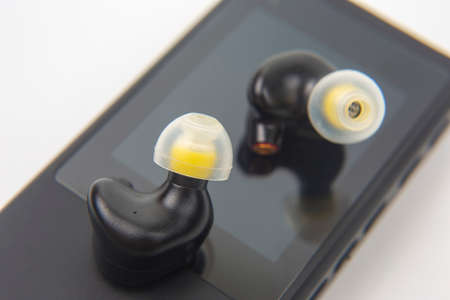 In-ear headphones for Hi-Fi music player. Audio sound and modern equipment for music lovers
