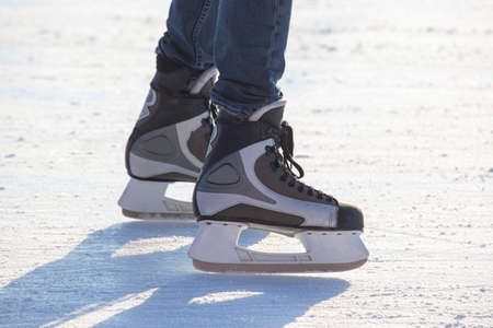 people ice skating on an ice rink. hobbies and leisure. winter sports