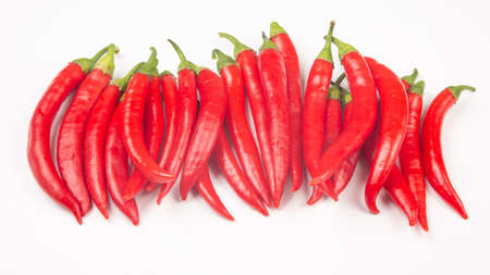 Red hot chili peppers on a white background. Vitamin vegetable food