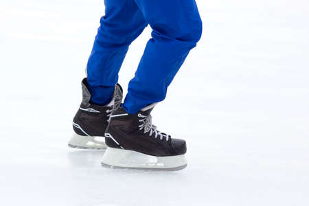 legs of a skating man on an ice rink. hobbies and leisure. winter sports