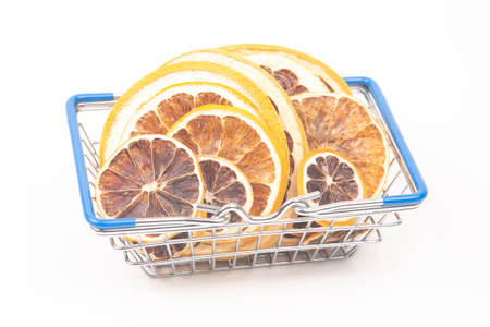 Dried citrus fruits in a market basket on a white background. Vitamin foodsの写真素材