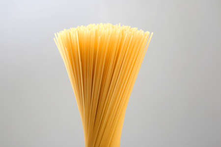 italian pasta spaghetti on a gray background. flour products and food in cooking