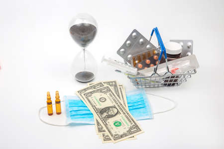 pills, ampoules and syringe for injection, medical mask, money and hourglass on a white background. business and medicine.の写真素材