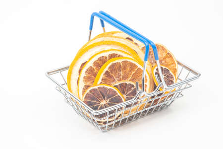 Dried citrus fruits in a market basket on a white background. Vitamin foodsの写真素材