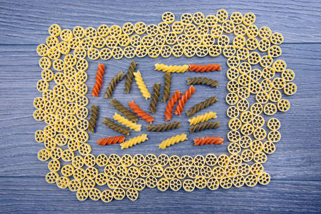 different types of italian pasta on a wooden background. flour products and food in cookingの写真素材