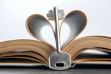 the key lies on the bible book. metaphor for discovering wisdom through the study of religious...