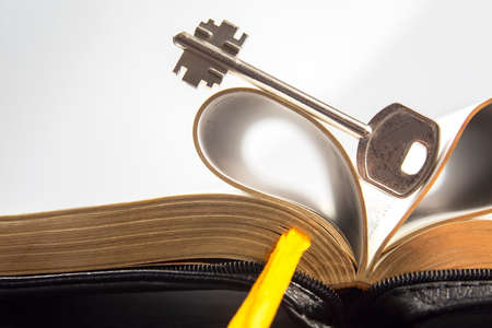 Key and open textbook of life. The book is the key and opening to knowledge and wisdom.の写真素材