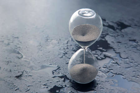 Hourglass on a dark background. Time is money. Business solutions in time.