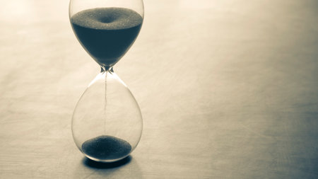 Hourglass on a light background. Time is money. Business solutions in time.