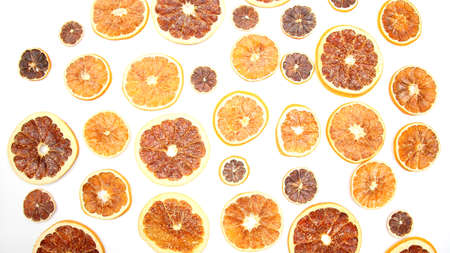 mix of different pieces of dried citrus fruit on white backgroundの写真素材