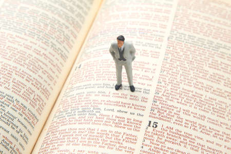 miniature people. man stands on the bible text. search for the path of life. I am the way.の写真素材