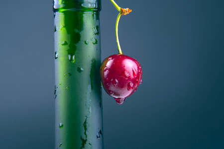 fresh cherry berry with water droplets on a green bottle. healthy food for breakfast. fruits of vegetation. fruit dessertの写真素材