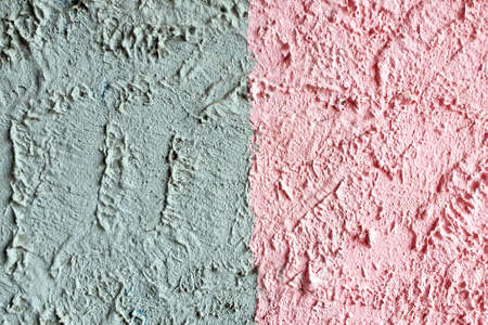 textured colored facing plaster of the street wall of the buildingの写真素材