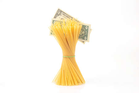 italian pasta with a dollar bill on a white background. flour products and food in cookingの写真素材
