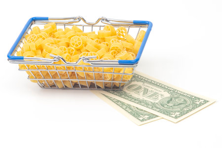 italian pasta with a dollar bill on a white background. flour products and food in cookingの写真素材
