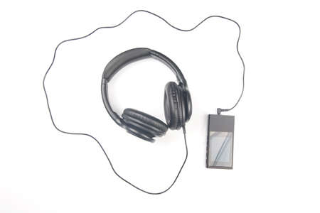 Headphones for listening to music with digital audio player on white backgroundの写真素材