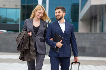 business partners man and woman walk together and have a dialogue