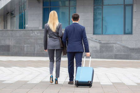 business partners man and woman walk together and have a dialogueの写真素材
