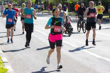 KHARKIV, UKRAINE - MAY 16, 2021: Kharkiv Half Marathon. Runners participating in a marathon run a...
