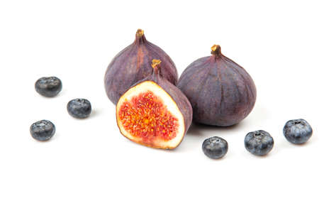 fresh figs and blueberries on a white background. Vitamin products