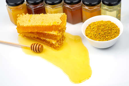 Fresh flower honey in combs and a wooden spoon. vitamin food for health and lifeの写真素材