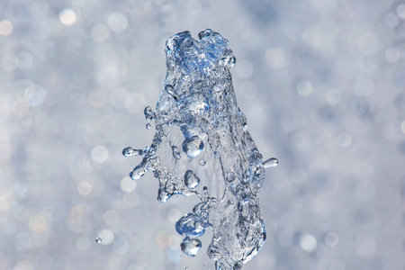 abstract figure of a water fountain on blurred backgroundの写真素材