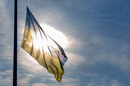 Flag of the state of Ukraine against the background of the bright sunの写真素材