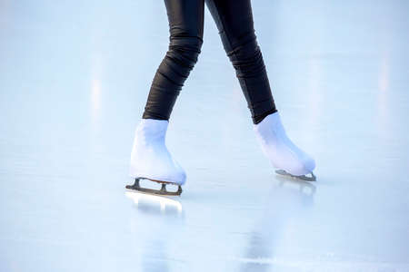 legs of a woman ice skating on an ice rink. hobbies and leisure. winter sportsの写真素材