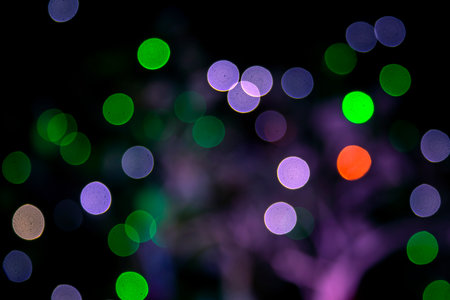 Colored blurred bokeh. abstract background of included festive garlands. colorful blur light bulbsの写真素材