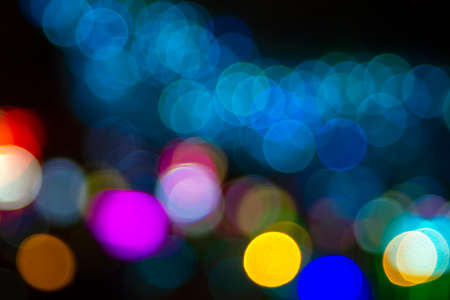 background blurred abstraction of colored lanterns and decorations. bokeh texture of street colored lightsの写真素材