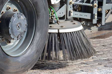 special vehicle for cleaning the road from dirt brushes the city street. road industry service