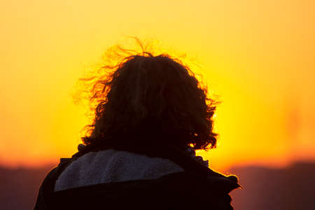 female hair against the setting sun.の写真素材