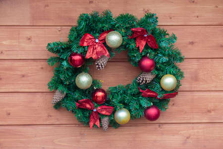 Christmas colorful decorative wreath on wood backgroundの写真素材