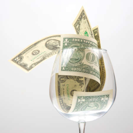 dollar banknotes money lies in an empty wine glass. business in the wine industry. alcohol marketing