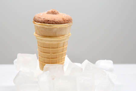 chocolate ice cream in a waffle cone glass in pieces of ice. dessert food