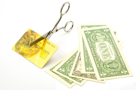 dollars, scissors and a credit card. business investment and customer service. banking. payment terminalの写真素材