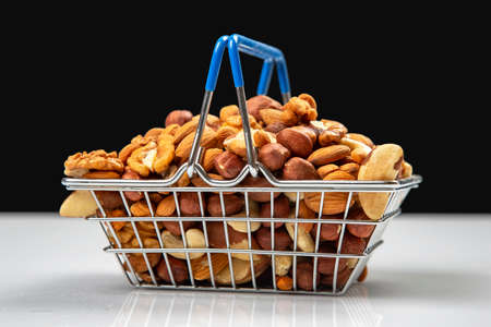 Various types of nuts in the grocery cart. Marketing sale of food products. Vitamin organic protein foodの写真素材