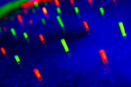 bright neon colored glowing diodes on a blue background