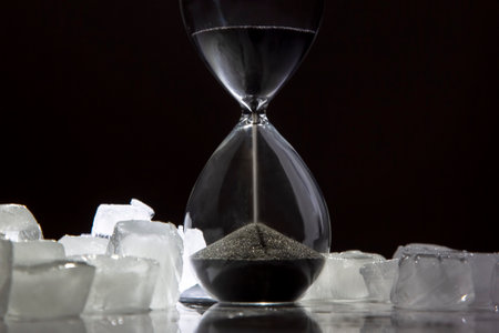 Hourglass on the background of ice cubes