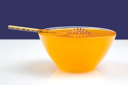 fresh honey from a spoon into a plate. organic vitamin health foodの写真素材