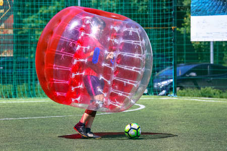 game on the field in transparent balloons. football ball game in inflatable transparent spheres. sports and entertainment. active recreation and hobbiesの写真素材