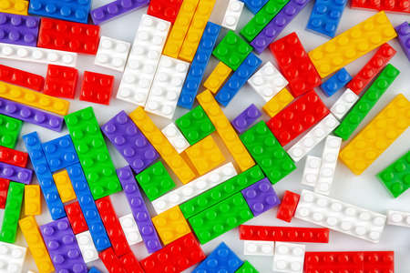 Abstract background texture of colored constructor blocks. Background of colorful plastic part of constructor. Pile of colored toy bricks.の写真素材